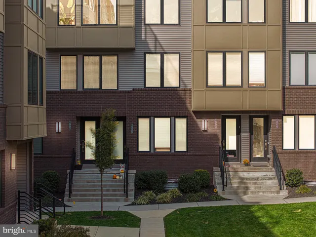 a front view of a house with yard and green space