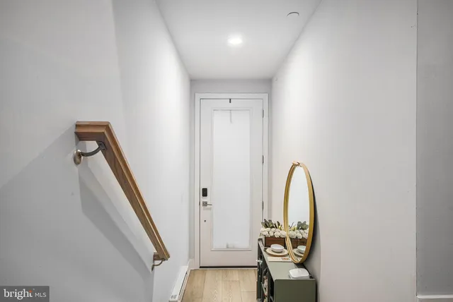 a kitchen with white cabinets and chairs