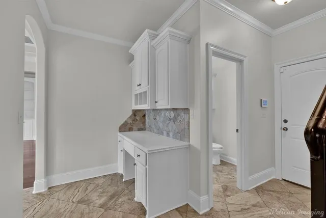 a room that has a stove and a granite countertop with white door