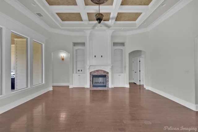 wooden floor in an empty room with a fireplace