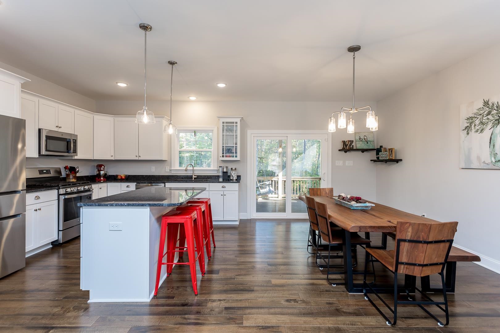 3768 Boundary Run Road Gum Spring, VA 23065 - Photo 12 of 46 a kitchen with stainless steel appliances granite countertop a dining table chairs stove a refrigerator and microwave