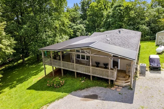 a front view of a house with a yard table and chairs