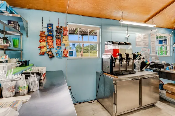 a kitchen with stainless steel appliances granite countertop a refrigerator a stove and a sink