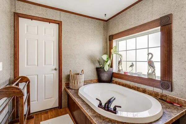 a kitchen with stainless steel appliances granite countertop a stove a sink dishwasher and a microwave with wooden floor