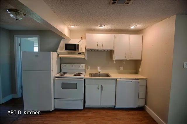 a kitchen that has a sink and a stove in it