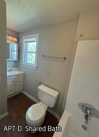 a bathroom with a toilet a sink and a window