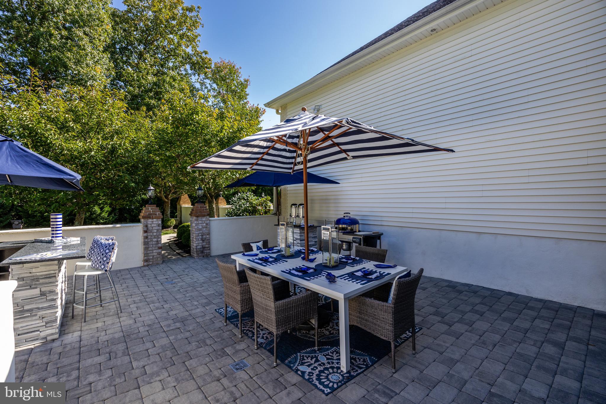 33 South Elmwood Road Marlton, NJ 08053 - Photo 74 of 98 a view of a patio with table and chairs under an umbrella