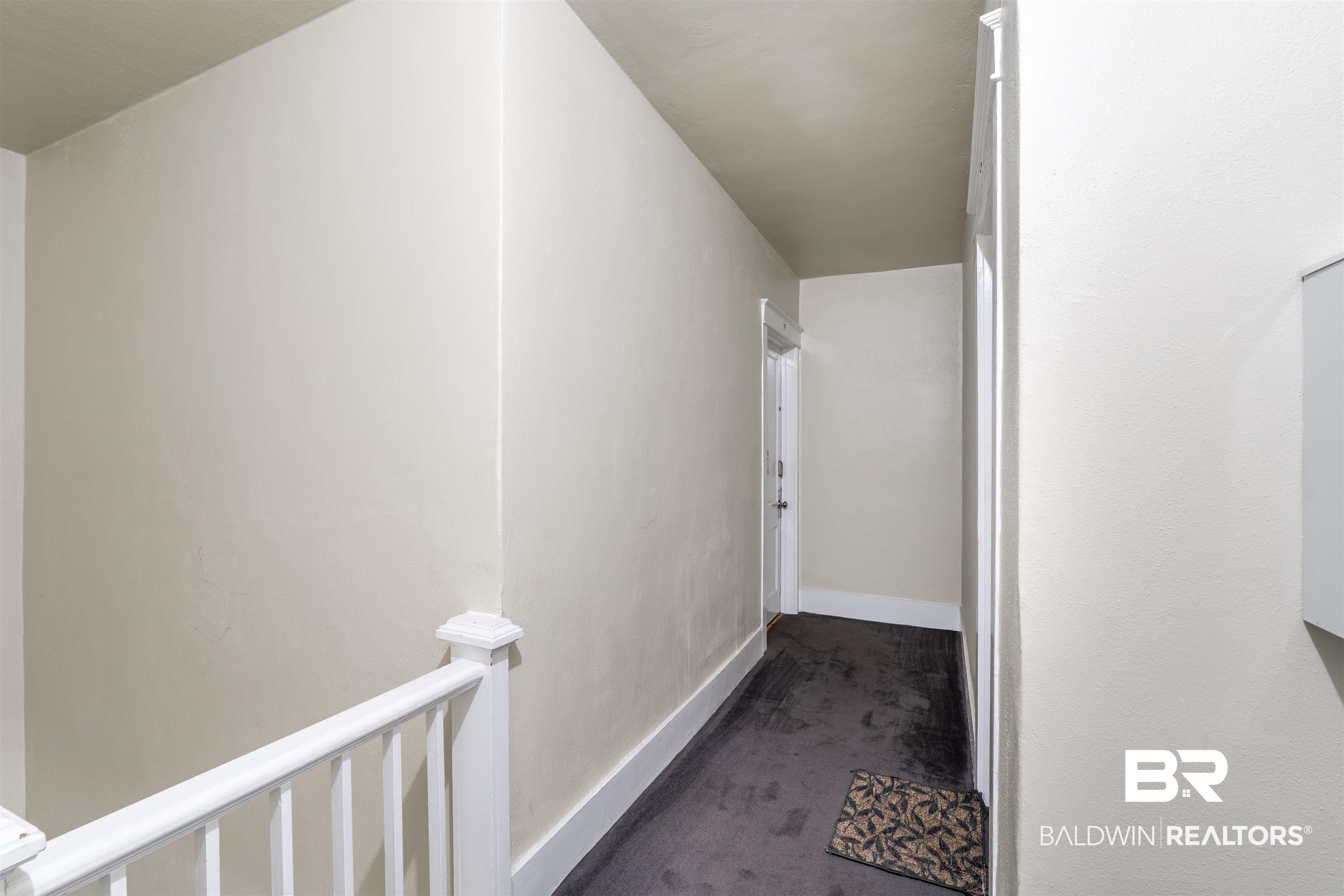 1600 Government Street, Unit 3F Mobile, AL 36604 - Photo 4 of 18 Corridor featuring carpet flooring, an upstairs landing, and baseboards