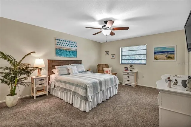 a bedroom with bed and a chandelier