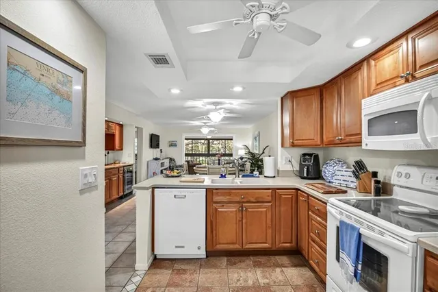 a kitchen with a sink cabinets and stainless steel appliances