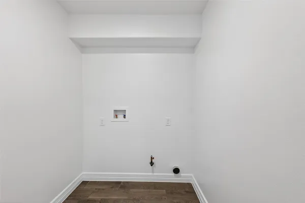 a bathroom with a bathtub shower sink vanity mirror and toilet