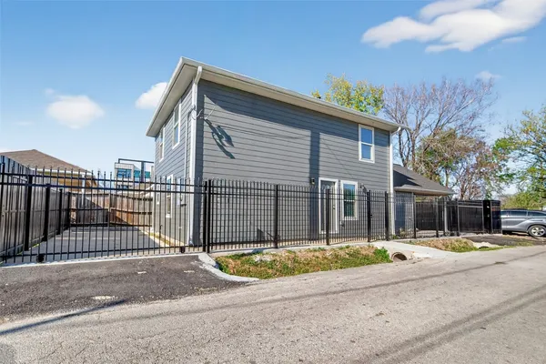 a view of a kitchen with a sink and dishwasher a stove top oven with wooden floor