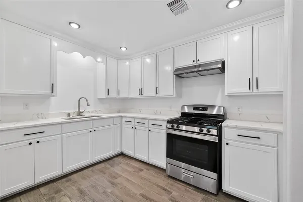 a view of a room with wooden floor and fan