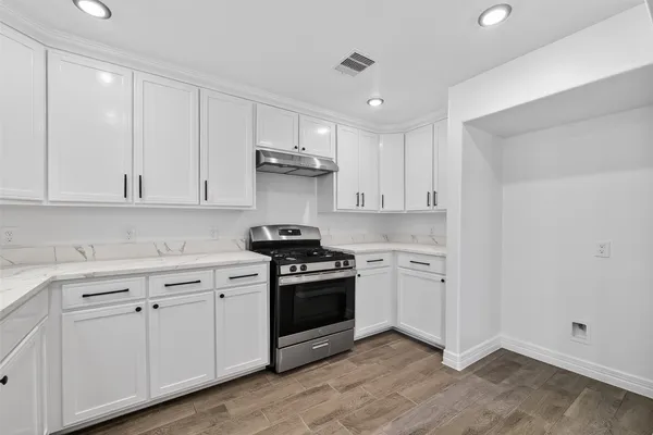 a view of empty room with wooden floor and window
