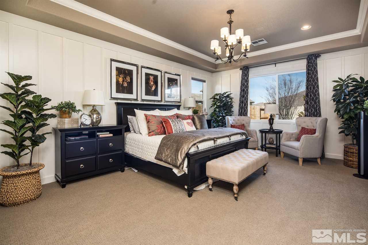 2089 Altair Lane Reno, NV 89521 - Photo 15 of 25 a spacious bedroom with a bed and a chandelier