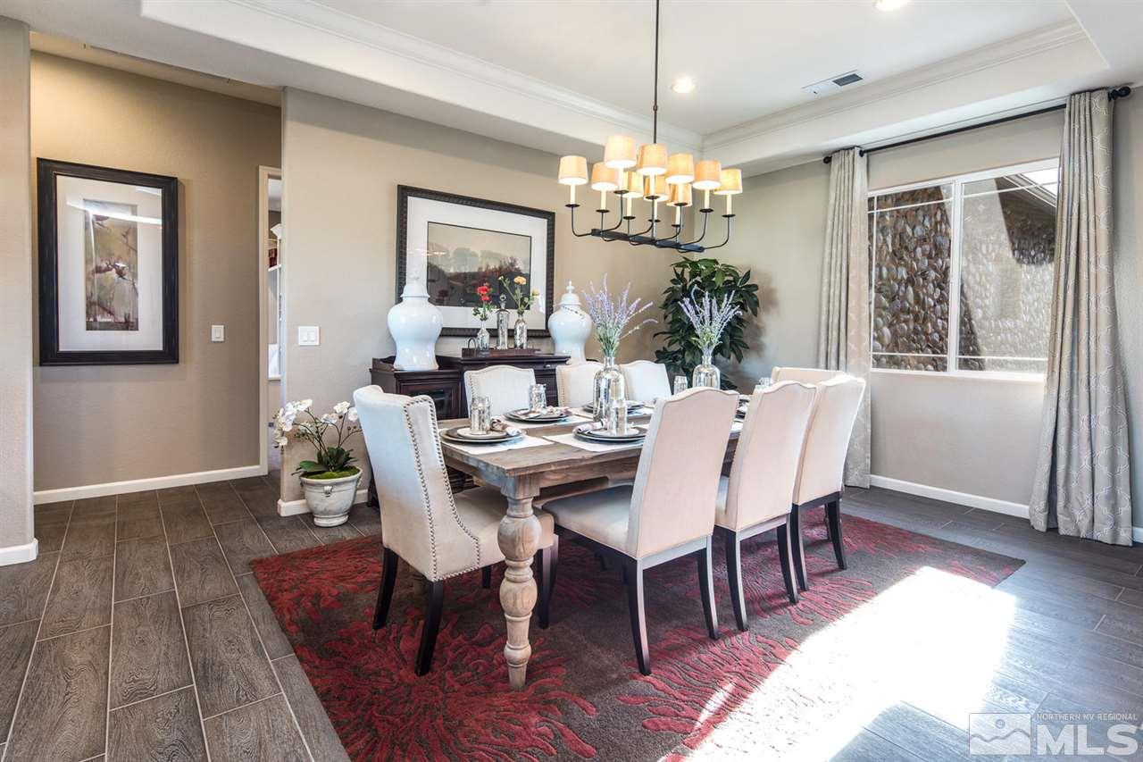 2089 Altair Lane Reno, NV 89521 - Photo 8 of 25 a view of a dining room with furniture a chandelier and wooden floor
