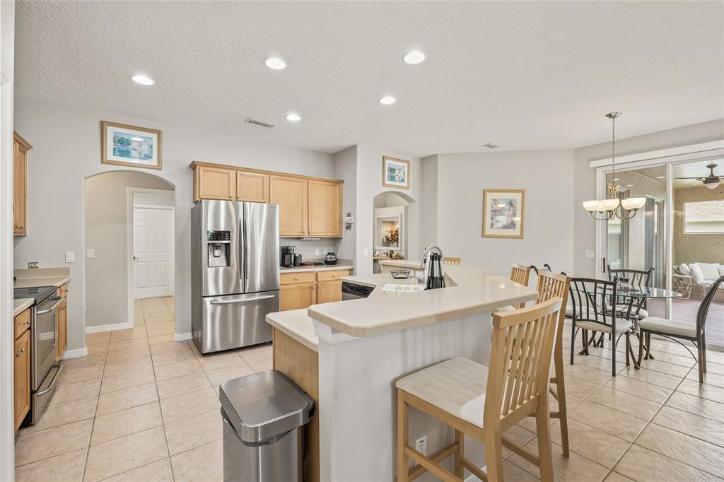144 Costa Loop Auburndale, FL 33823 - Photo 11 of 34 a large kitchen with a table and chairs