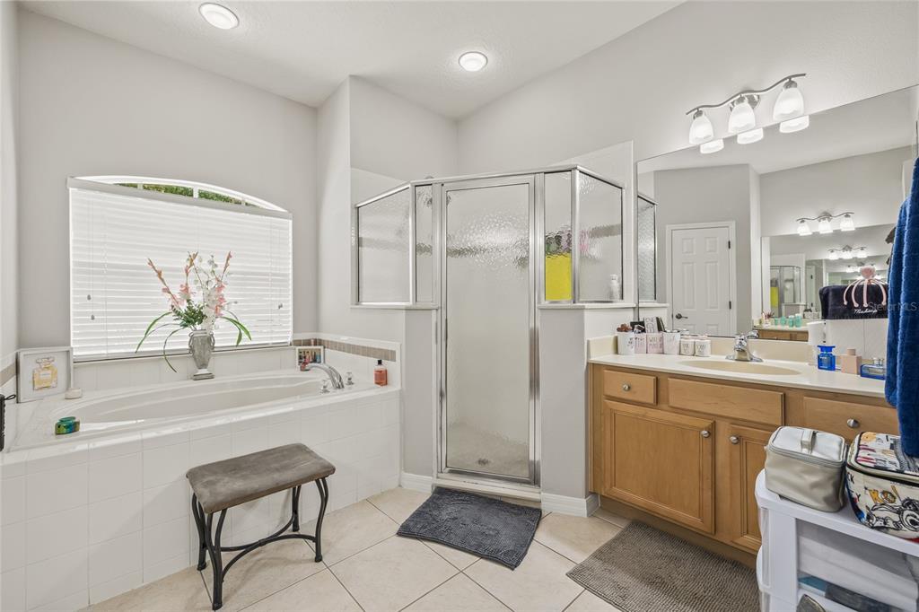 144 Costa Loop Auburndale, FL 33823 - Photo 18 of 34 a bathroom with a tub sink and mirror