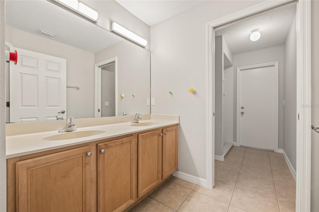 144 Costa Loop Auburndale, FL 33823 - Photo 23 of 34 a bathroom with a sink and a mirror