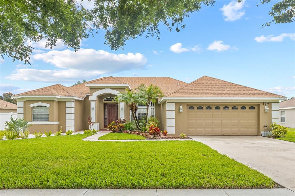 144 Costa Loop Auburndale, FL 33823 - Photo 33 of 34 a front view of a house with garden