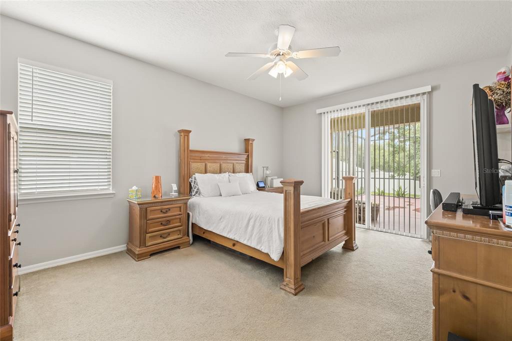 144 Costa Loop Auburndale, FL 33823 - Photo 4 of 34 a bedroom with a bed and a flat screen tv