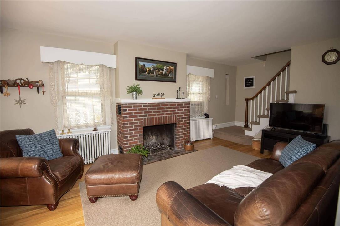 706 Stones Crossing Road Easton, PA 18045 - Photo 7 of 40 Another view of the cozy living room with hardwood flooring to complement the inviting brick fireplace in this comfortable living space.