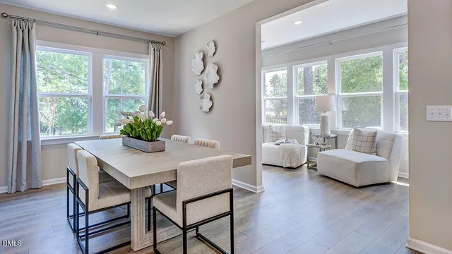 a bedroom with furniture and large windows