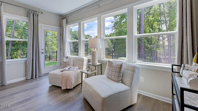 a living room with furniture a bookshelf and a window