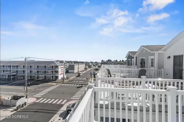 a view of a balcony with couches and wooden floor