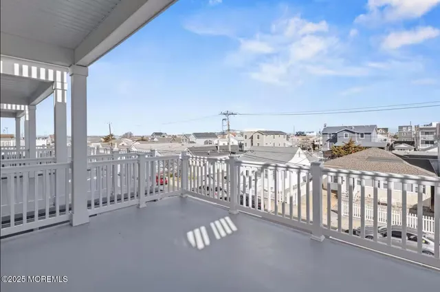 a view of a balcony with wooden floor