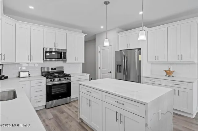 a large kitchen with a table and chairs