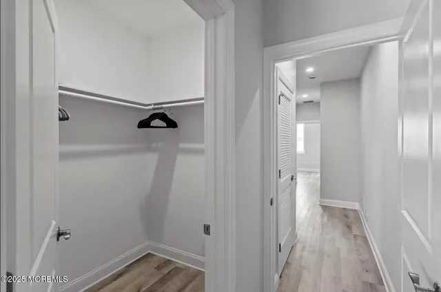 a bedroom with a bad and dresser