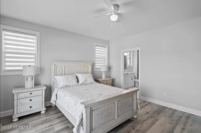a bedroom with a bed and a flat tv screen on dresser