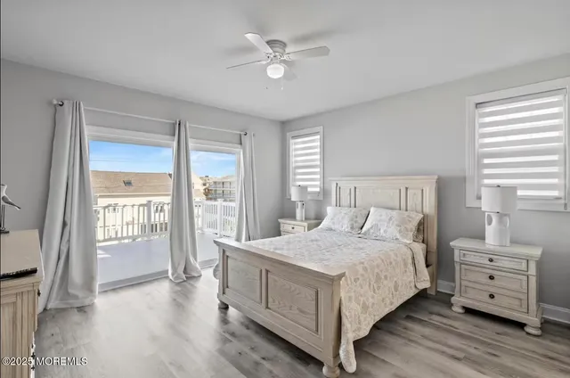 a kitchen with center island wooden floor center island and stainless steel appliances