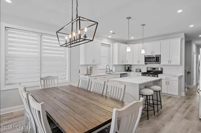 a kitchen that has a lot of cabinets and refrigerator
