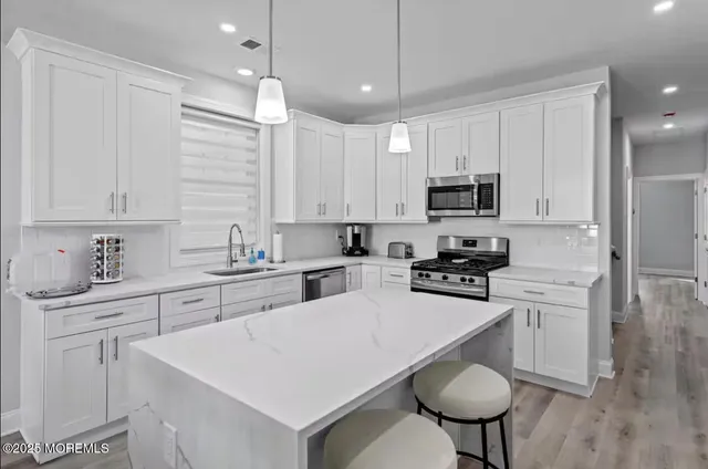 a view of a dining room with furniture a chandelier and wooden floor