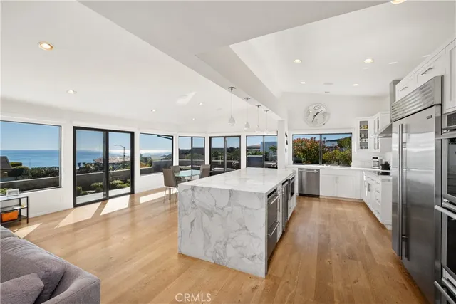 a view of a living room and floor to ceiling window and an outdoor view