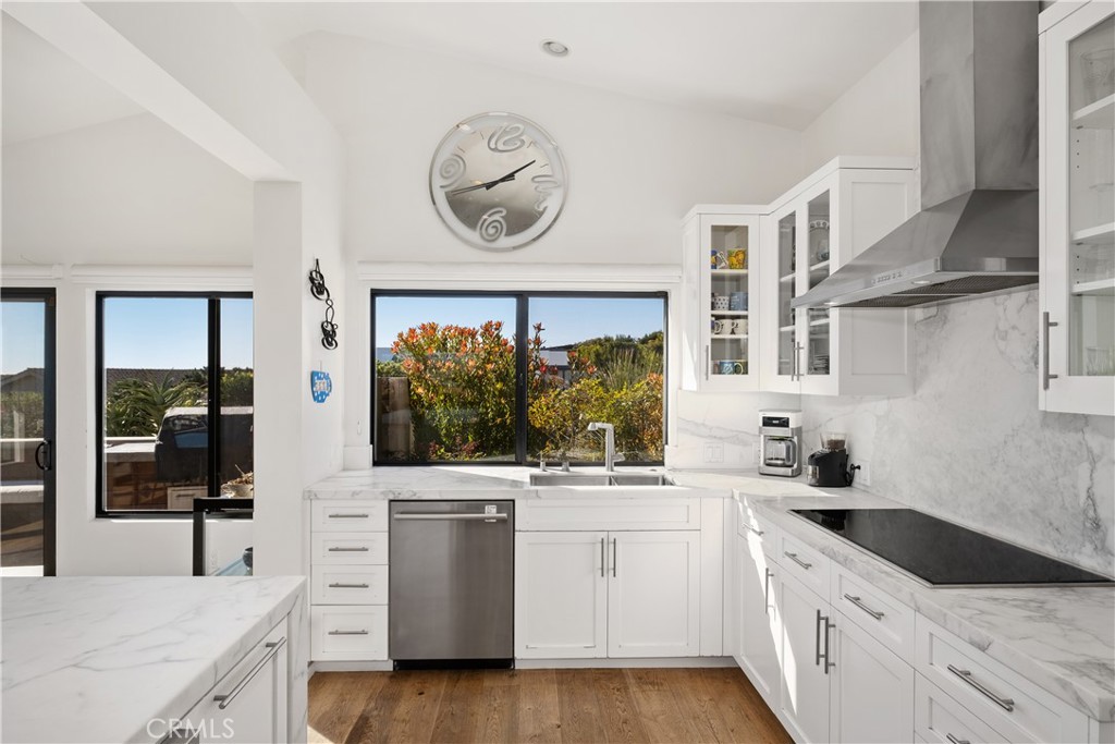 32182 Sea Island Drive Dana Point, CA 92629 - Photo 20 of 48 a kitchen with a stove oven and a clock on the wall