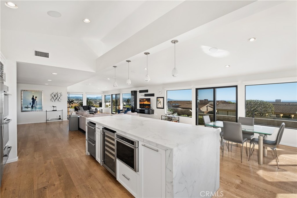 32182 Sea Island Drive Dana Point, CA 92629 - Photo 21 of 48 a large white kitchen with a large window and stainless steel appliances