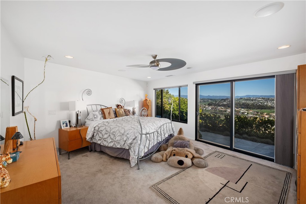 32182 Sea Island Drive Dana Point, CA 92629 - Photo 24 of 48 a bedroom with a bed and large windows
