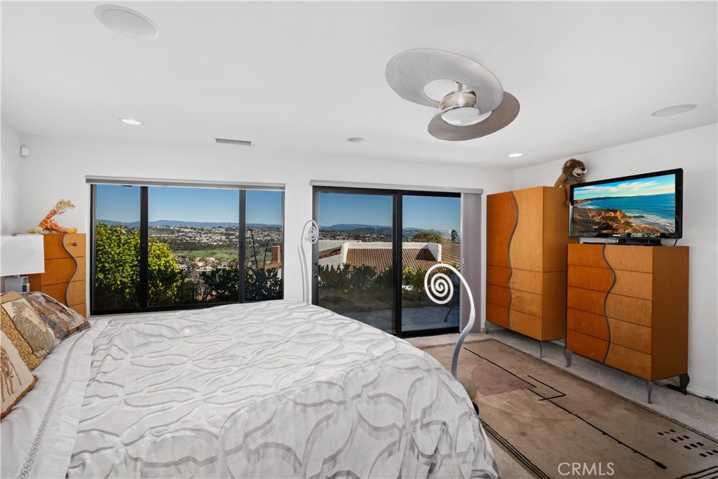 32182 Sea Island Drive Dana Point, CA 92629 - Photo 25 of 48 a bedroom with a large bed and a chandelier