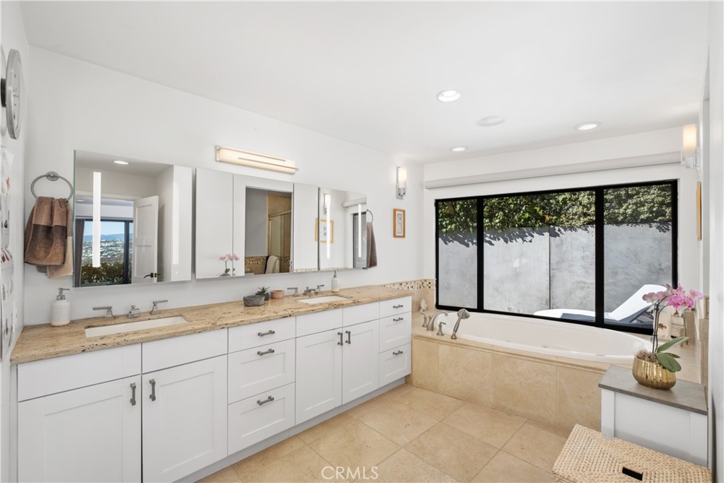 32182 Sea Island Drive Dana Point, CA 92629 - Photo 26 of 48 a spacious bathroom with a large mirror vanity and a shower