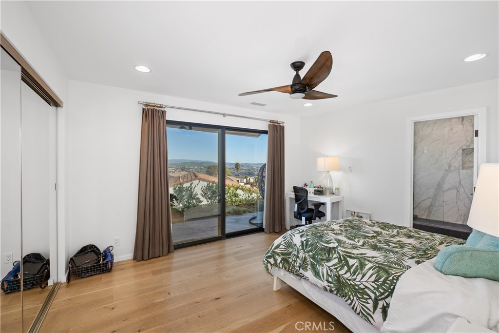 32182 Sea Island Drive Dana Point, CA 92629 - Photo 30 of 48 a bedroom with a bed and wooden floor