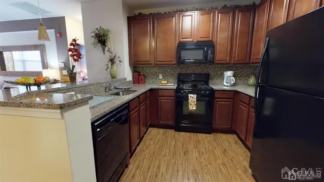 a kitchen with stainless steel appliances granite countertop a sink stove microwave and cabinets