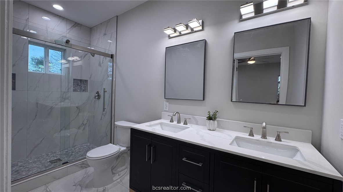 3917 Harbor Bolton Road Franklin, TX 77856 - Photo 11 of 26 a bathroom with a double vanity sink toilet and shower