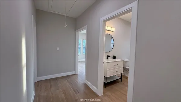 a room with a mirror and a lamp