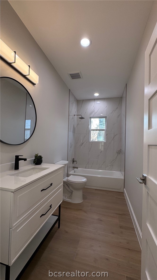 3917 Harbor Bolton Road Franklin, TX 77856 - Photo 15 of 26 a bathroom with a double vanity sink toilet mirror and bathtub