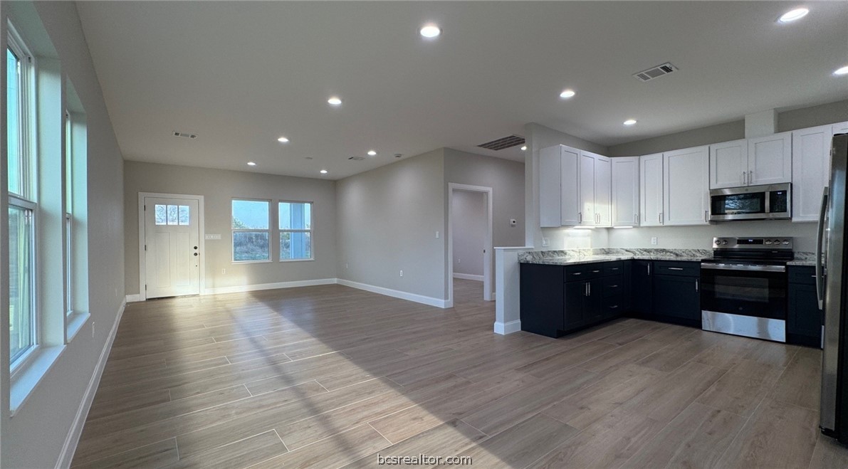 3917 Harbor Bolton Road Franklin, TX 77856 - Photo 19 of 26 a kitchen with granite countertop a stove top oven and cabinets