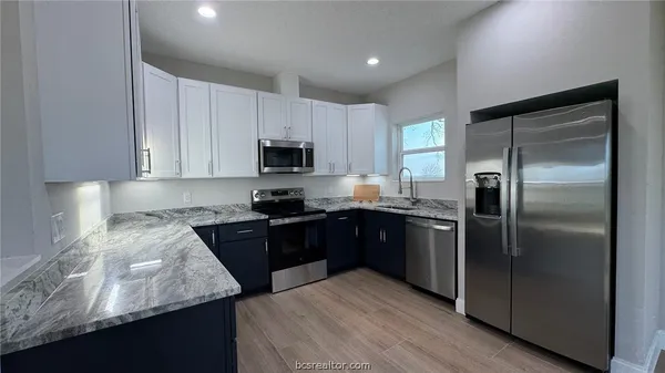 a kitchen with a refrigerator stove and microwave