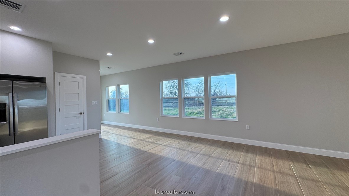 3917 Harbor Bolton Road Franklin, TX 77856 - Photo 5 of 26 an empty room with wooden floor and windows